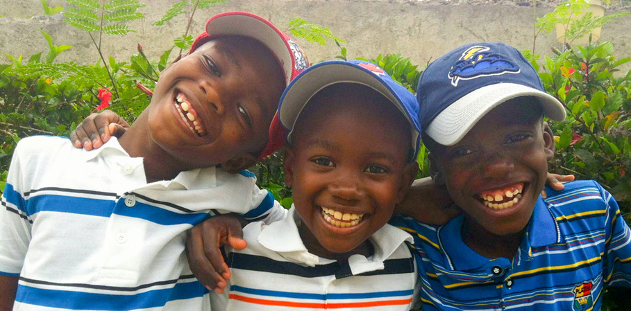 photo of three smiling young boys at Center of Hope, Haiti